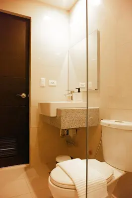 a bathroom with a toilet and a sink at Uptown Parksuites Apartments Tower 2 BGC by PH Staycation in Manila