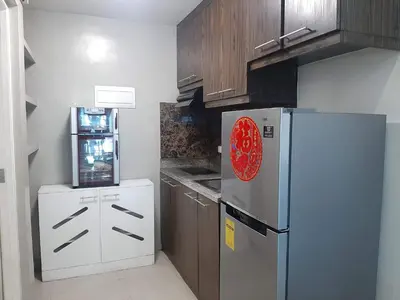 a kitchen with a refrigerator and a stove at Comfy Bunkbed with Pool in Manila