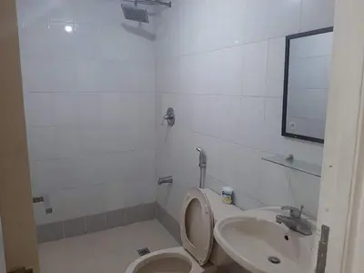 a bathroom with a toilet and a sink at Comfy Bunkbeds at BSA in Manila