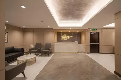 a lobby with a waiting room with chairs and a counter at The Belamy House Managed by HII in Manila