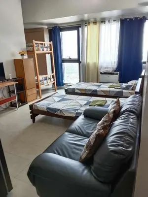 a room with three beds and a couch in it at Family Staycation 2 with Pool in Manila