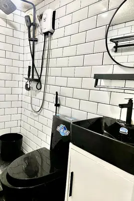 a bathroom with a black sink and a shower at IV’s Condo w/ Netflix and Wi-Fi in Cainta