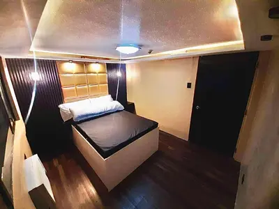 a small room with a bed in the middle at IV’s Condo w/ Netflix and Wi-Fi in Cainta
