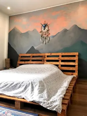 a bedroom with a bed with a painting on the wall at Boho Inspired Home Near Rockwell in Manila