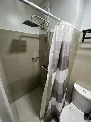 a bathroom with a shower and a toilet at SHORE TOWER 1 Staycation Near Mall Of Asia in Manila