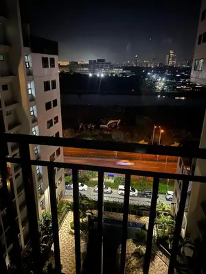 a view of a city at night from a balcony at SHORE TOWER 1 Staycation Near Mall Of Asia in Manila