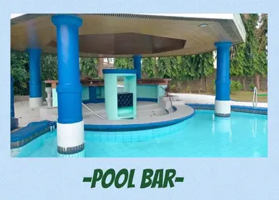 a pool bar with blue columns in a swimming pool at Family Friendly Cozy Village Stay Sta Rosa Belair in Santa Rosa