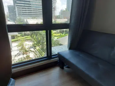 a couch in front of a window with a view at Flair Towers STUDIO ROOMS Staycation in Manila