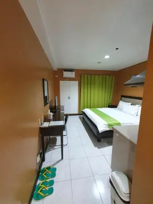 a hotel room with a bed and a desk with a desk at SAB R.CONDOTEL and room rental in Manila
