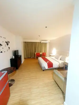 a hotel room with a bed and a table at SAB R. CONDOTE'L SUITES in Manila