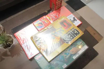 a table with three books on top of it at A2J Luxury 2BR Suite Near High Street BGC Taguig in Manila