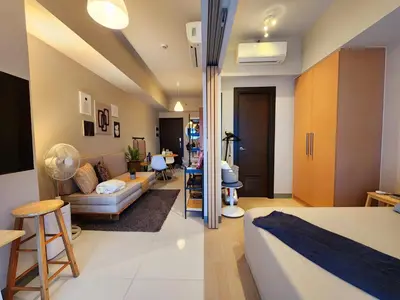 a living room with a couch and a table at 7 BGC Shopping Haven Steps Away from Uptown Mall and Mitsukoshi Mall FREE Parking with Washer in Manila