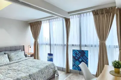a bedroom with a bed and a large window at Cosy Executive 1 BR Uptown Parksuites Ultra fast Internet in Manila