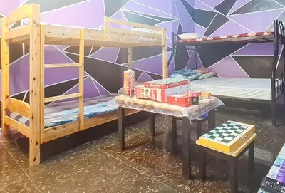 a room with two bunk beds and a table at Yuzons Bedspacer and Transient Home Staycation in Manila