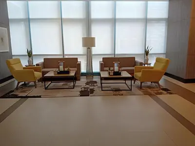 a lobby with couches and chairs and a table at One Uptown Opposite of grandhyatt hotel manila Taguig city in Manila