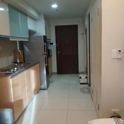 a kitchen with a refrigerator and a door to a room at One Uptown Opposite of grandhyatt hotel manila Taguig city in Manila