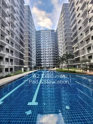 a swimming pool in front of tall buildings at A2 Executive Pad & Staycation in Manila