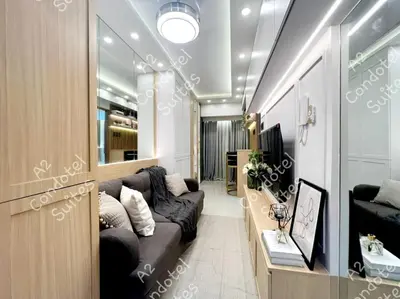a living room with a couch and a tv at A2 Executive Pad & Staycation in Manila