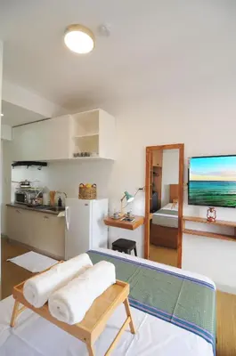 a living room with a kitchen and a refrigerator at R'Holistay Grace Taguig Fast Wifi Self Check In in Manila