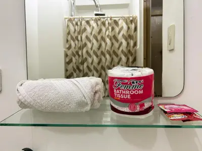 a glass counter top with a container of bathroom tissue at 1BR Homy Furnished Unit Grace Residences Taguig in Manila