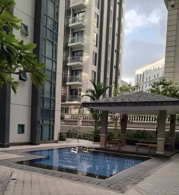 a swimming pool with a gazebo and buildings at Palmtree Villas Two Condotel Near Airport in Manila