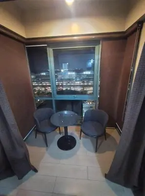 a room with a table and two chairs and a window at Palmtree Villas Two Condotel Near Airport in Manila