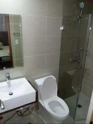 a bathroom with a shower and a toilet and a sink at Transient Near Airport by Rqui in Manila