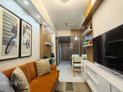 a living room with a couch and a flat screen tv at Happirest at Shore 3 Residences with Balcony, Mall of Asia in Manila