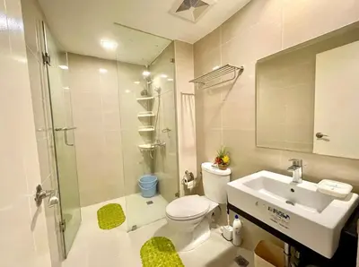 a bathroom with a toilet and a sink and a shower at Luxury 1BR Unit with Pool at Venice Luxury Residences, Tower Domenico, McKinley Hill, Taguig City in Manila