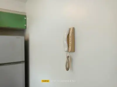 a phone hanging on the side of a wall at WestParc Cedar Alabang in Manila