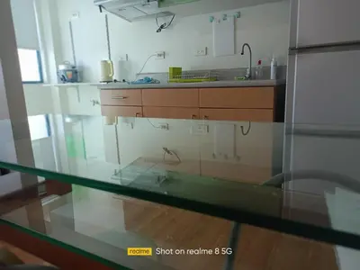 a glass counter top in a kitchen with a sink at WestParc Cedar Alabang in Manila