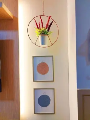 a hallway with three pictures and a potted plant on a wall at Spring Residences Scandinavian 2 bedrooms with balcony Near NAIA in Manila