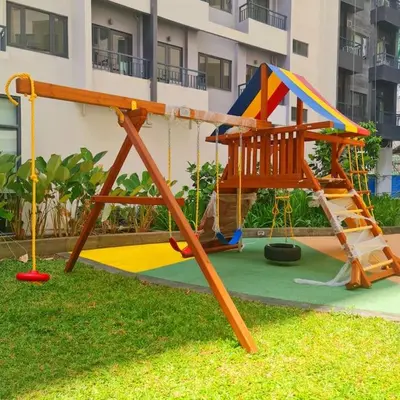 a playground in a yard with a swing at Spring Residences Scandinavian 2 bedrooms with balcony Near NAIA in Manila