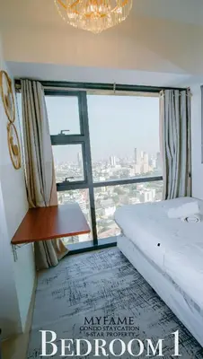 a bedroom with a bed and a large window at 2BR SMDC Premium Unit: FAME Residences 31st FLOOR in Manila