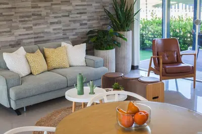 a living room with a couch and a table at Orchard Tiny Home - Golf Course Pet Friendly Lot in Baluctot
