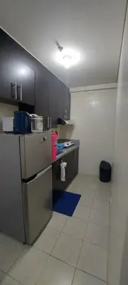 a kitchen with a stove and a counter top at Rochester Condo in Manila