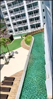 a pool of water in front of a building at Breeze Residences - 1BR Unit with Balcony -Top Floor in Manila