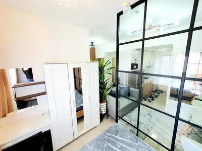 a room with glass walls and a mirror at Green 2 Residences Scandi-Industrial Hotel Type Interior in Dasmariñas