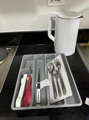 a tray filled with utensils on a kitchen counter at Shore 2 Apartment with Balcony in Manila