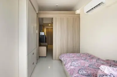 a bedroom with a bed and a room with a television at Luxury Sunset Views and Prime Location near CCP MOA with WIFI Parking in Manila