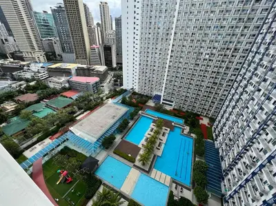 an overhead view of a pool in a city at JAZZ Residences - 1 Bedroom with Balcony - Cable, Wifi & Netflix in Manila