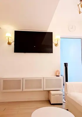 a living room with a flat screen tv on the wall at Azure SKYVIEW PENTHOUSE minimalist unit in Manila