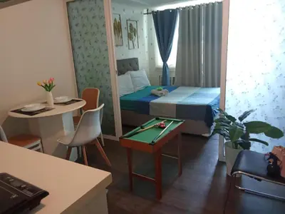 a small room with a bed and a table at Azure Urban Resort with WIFI and Netflix in Manila