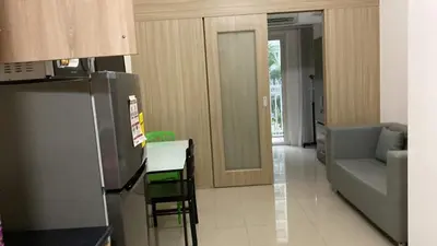 a kitchen with a refrigerator and a table and a couch at Shell Residences C15 Shortwalk Sm Mall Of Asia/Airport in Manila