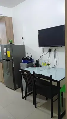 a desk with a television on top of it at Shore Residence D12 Near Airport- SM Mall Of Asia in Manila