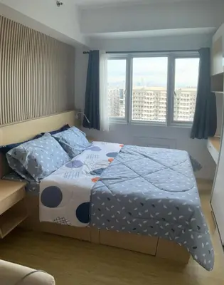 a bedroom with a bed and two pillows on it at SEA Residences in Pasay near Mall of Asia in Manila