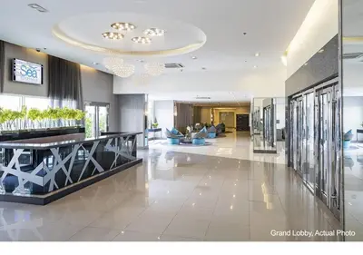 a lobby of a hotel with couches and a lobby at SEA Residences in Pasay near Mall of Asia in Manila