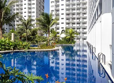 a large swimming pool in the middle of a building at Shore Residences MOA Staycation in Manila