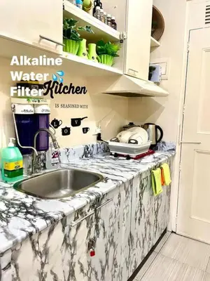a kitchen with a sink and a counter top at Borbon's Condo Suite in Manila