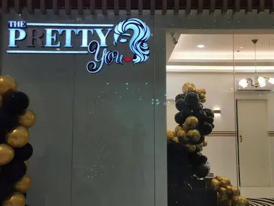 a sign that says the pretty you on a wall with balloons at Crib's nr.BGC in Manila